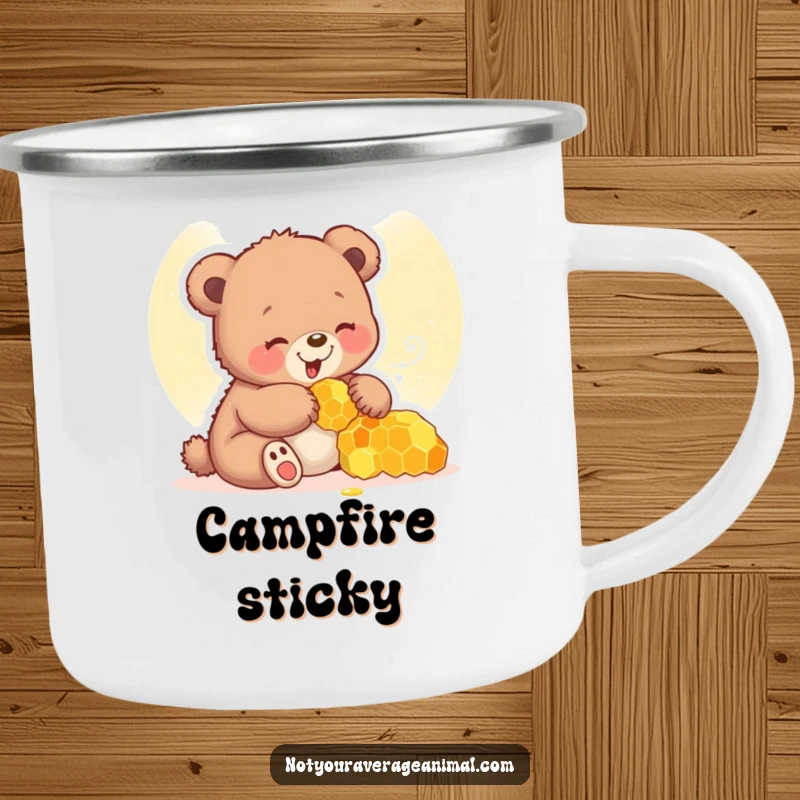 Funny bear cub camping mug showing a giggling cub playing with a honeycomb, designed for outdoor enjoyment.