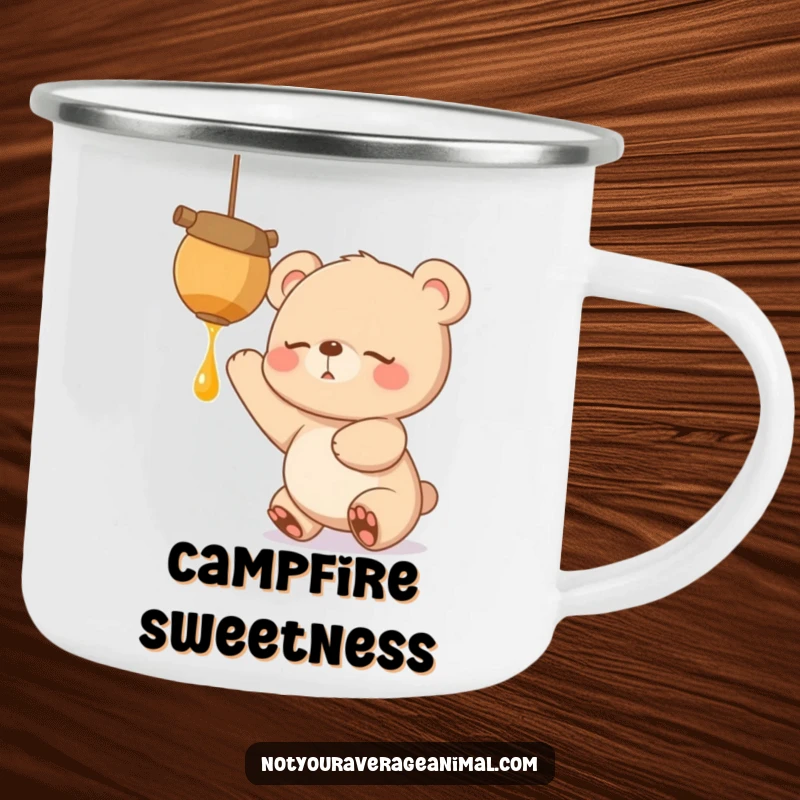 Funny enamel camping mug with a sleepy bear cub reaching excitedly for a dangling honeypot, ready for outdoor sweetness.