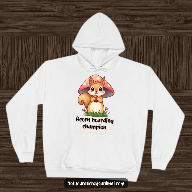 Funny Squirrel Hoodie: A curious squirrel peeks from a mushroom, clutching an acorn, offering warmth and humor for chilly days.
