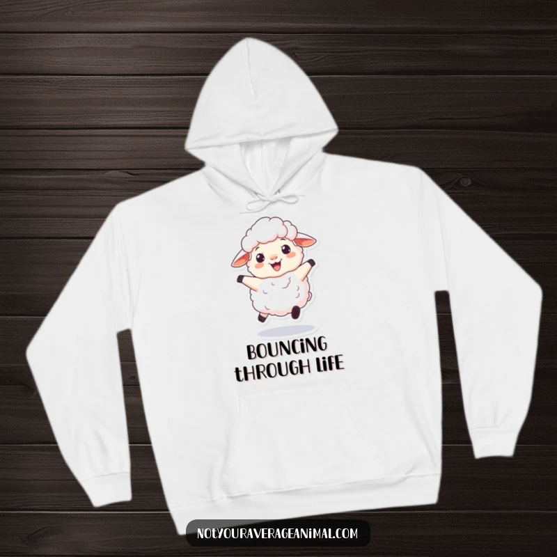 Funny and cozy hoodie featuring a fluffy sheep character joyfully bouncing with a large, woolly grin, perfect for spreading cheer.