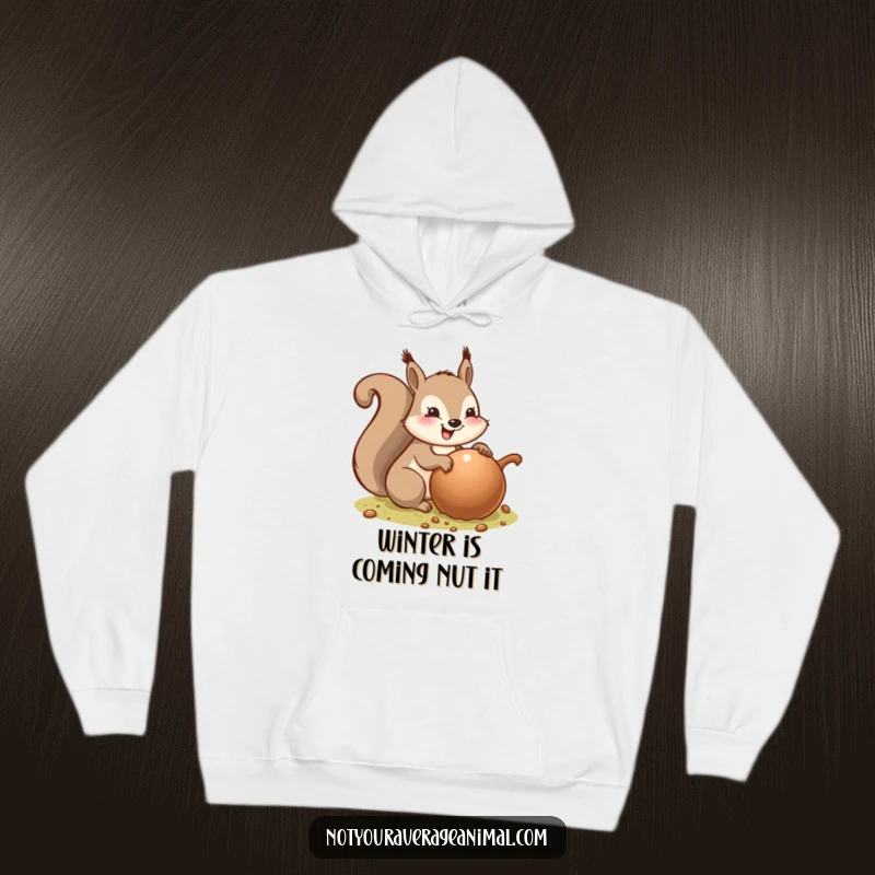 Funny hoodie with a delighted squirrel burying an enormous acorn, showcasing a cozy yet comical scene of winter preparedness and pure joy.