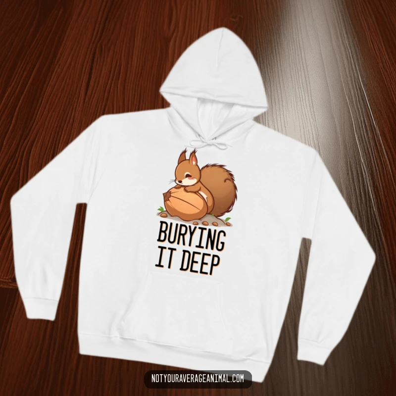 Funny hoodie depicting a determined squirrel with a full tail burying a gigantic nut, a cozy and comical winter apparel design.