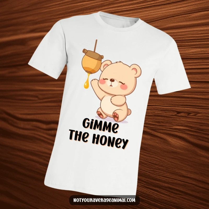 Funny t-shirt of a sleepy bear cub with big, hopeful eyes, excitedly stretching to grab a dangling honeypot, craving sweetness.